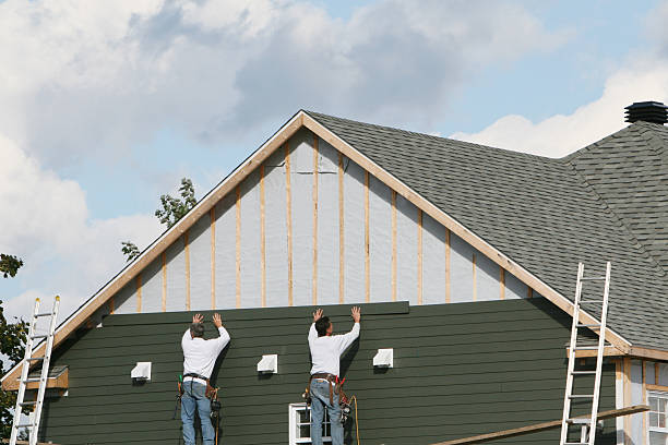 Professional Storm Damage Siding Repair technician working in Carlisle, MA